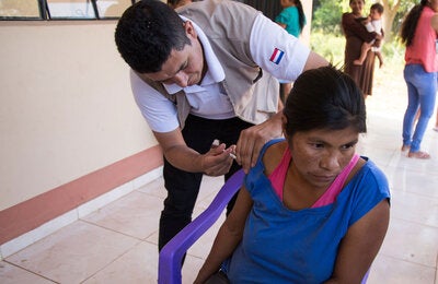 Woman in a remote location receives vaccination