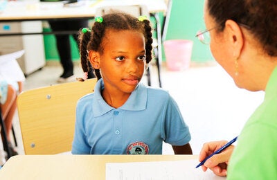 Girl and health worker in a school in Dominican Republic