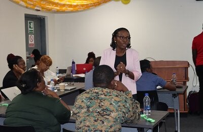Dr. Claudina Cayetano PAHO's Mental Health Regional Advisor speaking with participants.