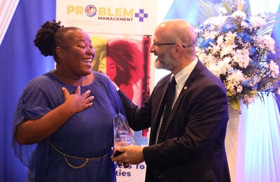 PWR Ian Stein presents an award to a PM+ graduate