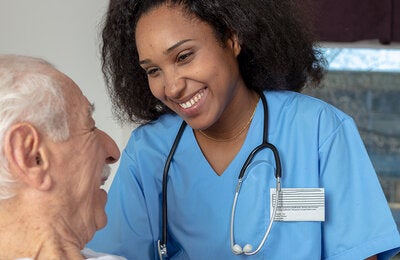 Nurse caring for elderly patient