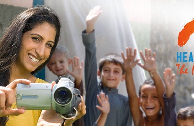 Woman with camera and children behind her