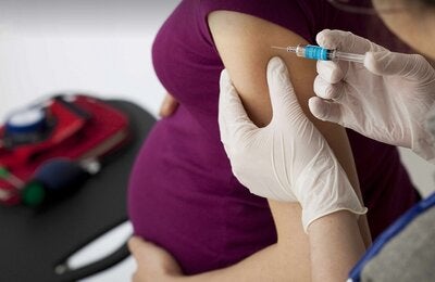 Embarazada recibiendo vacuna