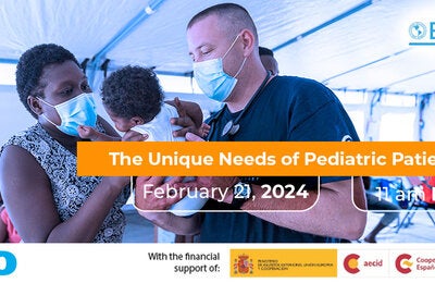 A mother and a frist responder holds a baby inside a hospital