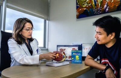 Patient and doctor discuss  liver diseases