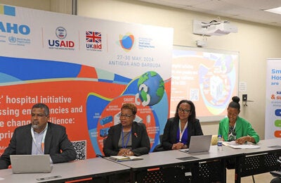2 women, emergency medical team members, checking their supplies inside the movil hospital