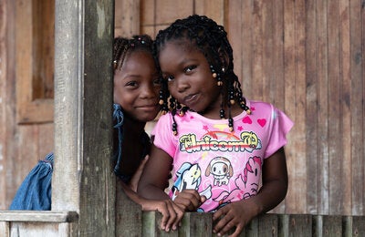 Young girls pose around post