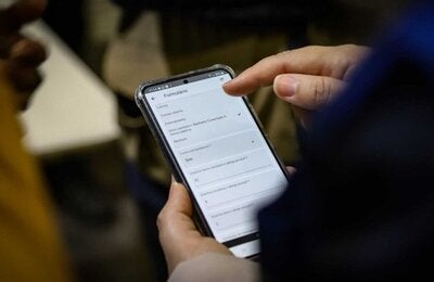 Person holding phone with EWARS, cell phone app