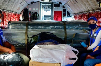 PAHO Response Team members ready to deploy, using face masks and wearing blue vests and caps