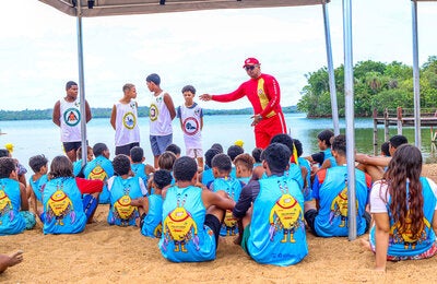 Brazil, firefighters lead various educational, preventive, and rescue initiatives. Here they are speaking to children.