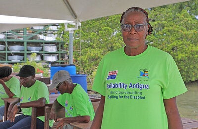 Woman displaying "Sailbiity Antigua" t-shirt