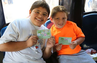 Boys show their vaccination record cards