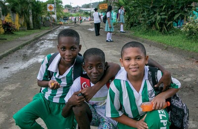 Happy boys playing in the street, posing to the camera