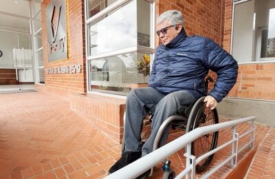 Ricardo on a wheelchair navigating a ramp