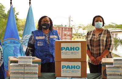 Chief Executive Officer of the Ministry of Health and Wellness Belize, Dr. Deysi Mendez, accepting donated items from PAHO/WHO Representative of Belize, Dr. Noreen Jack.