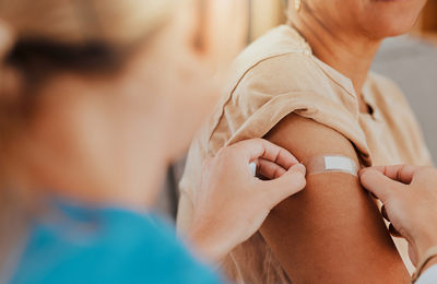 Patient after being vacciated gets a bandaid