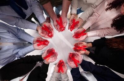 in a circle holding ribbons