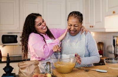 Mother and daughter cooking together