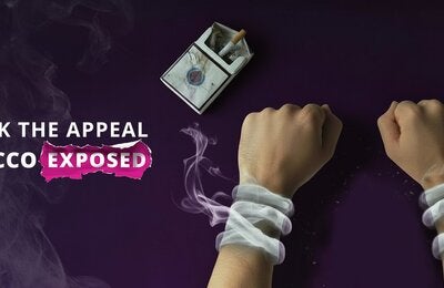 Hand handcuffed by smoke provenant from a package of cigarrettes and a dirty ashtray