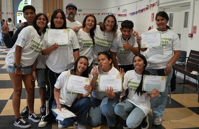 Young participants group photo holding up certificates