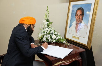 Dr. Prabhjot Singh signs Sir Garfield Sober's condolence book on behalf of PAHO/WHO