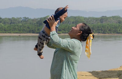 Madre cargando a hijo en el Amazonas
