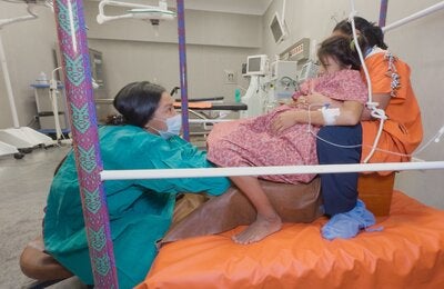 Woman in labor assisted by two health professionals at the Intercultural Hospital of Atalaya, in Ucayali, Peru.