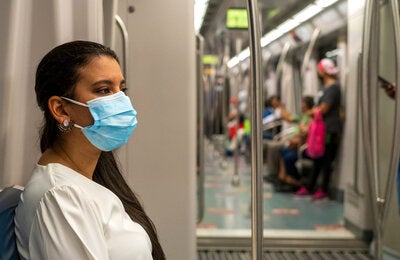 Woman wearing mask while using public transportation