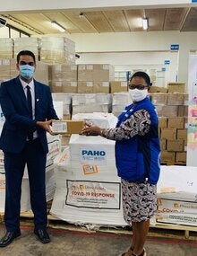 Dr. Karen Lewis-Bell, PAHO/WHO Representative in Suriname hands over a donation of COVID-19 supplies for case management to Dr. Amar Ramadhin, Minister of Health
