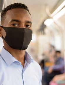 Man wearing mask using public transportation