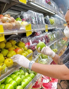 Woman buying fruit in a supermarket