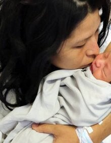 Woman kissing her baby