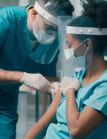 health worker getting vaccinated