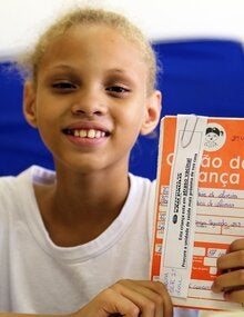 Young girl shows her HPV vaccination certificate in Brazil