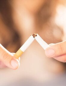woman breaking cigarette