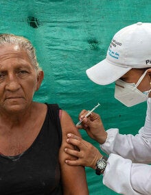 Older adult receives vaccine.