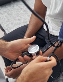Doctor checks patient's blood pressure