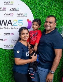 A happy family at the Vaccination and Health Fair for VWA25