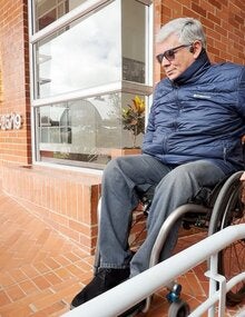 Ricardo on a wheelchair navigating a ramp
