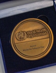 World No Tobacco Day award medal in a blue box.
