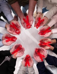 in a circle holding ribbons