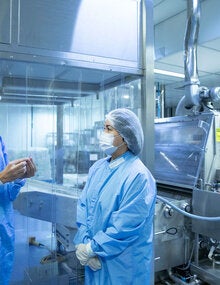 Luiz Lima, Deputy Director of Production at Bio-Manguinhos-Fiocruz, working with a colleague.