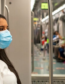 Woman wearing mask while using public transportation