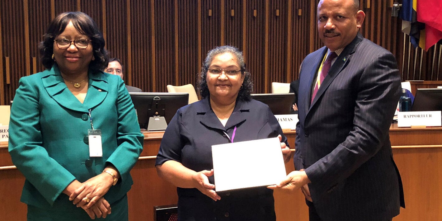 Dr. Natalia Largaespada Beer of Belize receiving her award