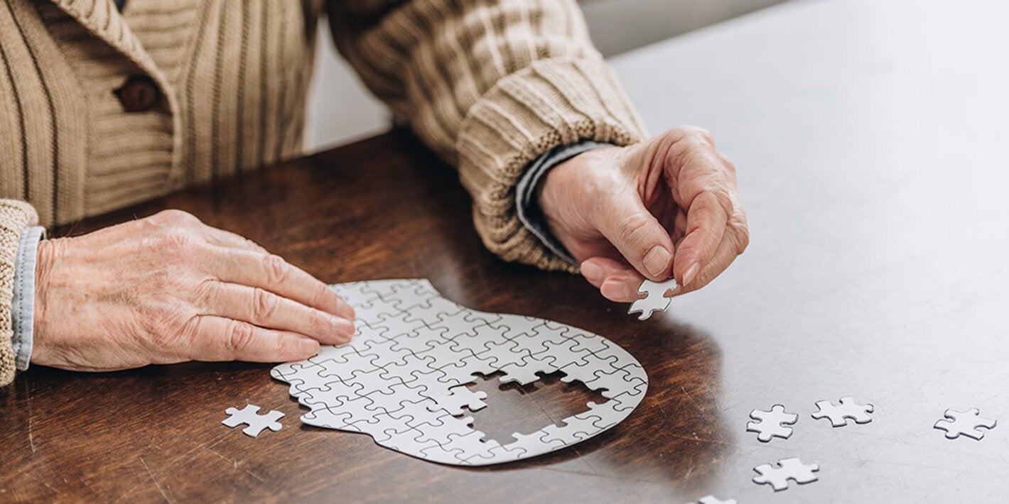 Old adult solving puzzle