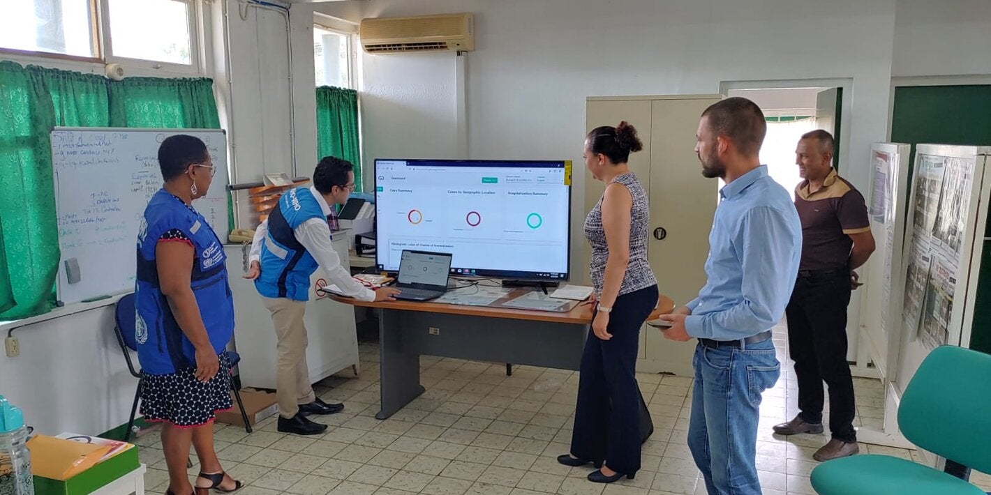 Dr. Cleopatra Jessurun, Director of Public Health being trained on key features of the Go.Data system with support from BOG, PAHO and IDB staff