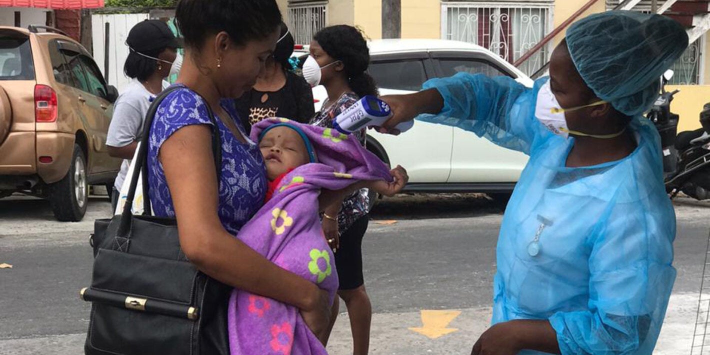 health worker taking temperature