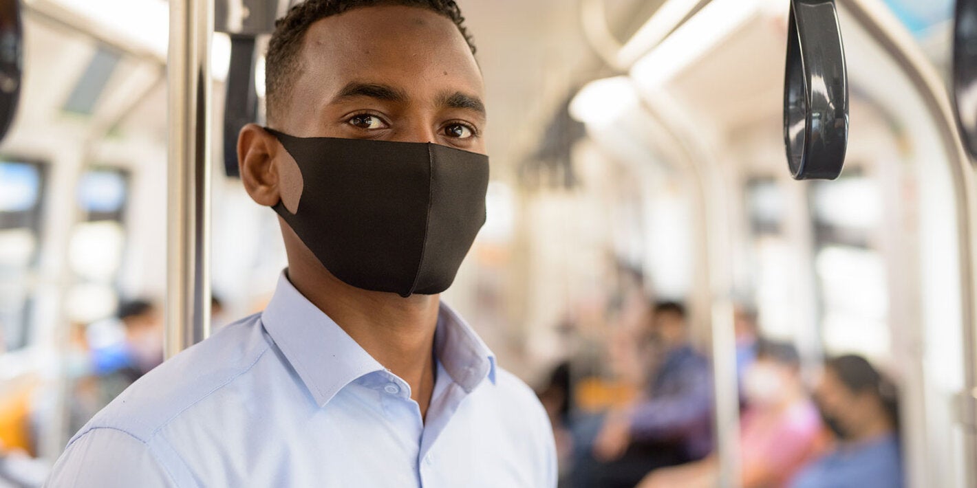 masked man riding bus