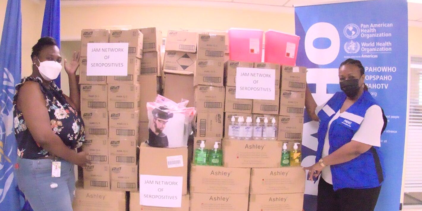 (L-R) Karraine Dillion, Finance Office, Jamaica Network of Seropositives (JN+), pictured in high spirits after receiving personal protective equipment from the Pan American Health Organization (PAHO). Also pictured is Dr. Audrey Morris, Acting Pan American Health Organization/World Health Organization Representative for Jamaica, Bermuda and the Cayman Islands.  