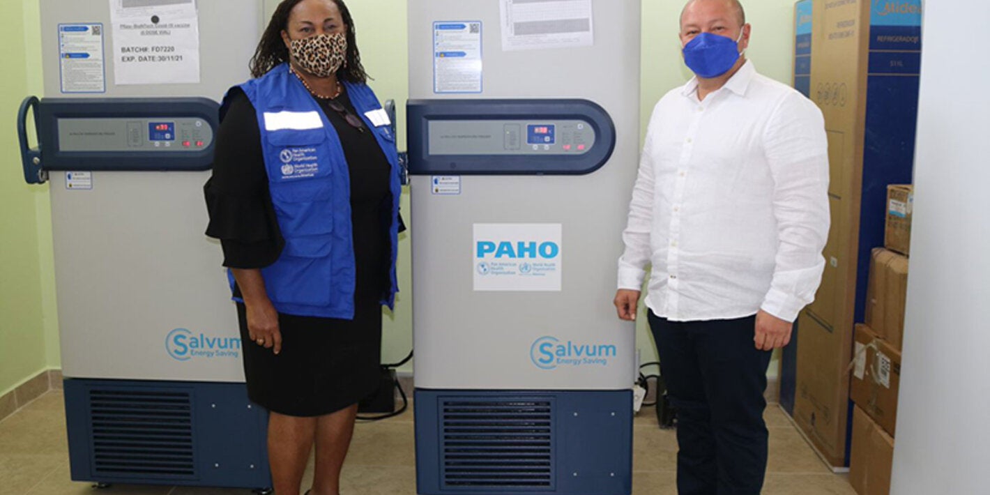 Photo of PWR and Minister of Health flanking the ULT Freezer